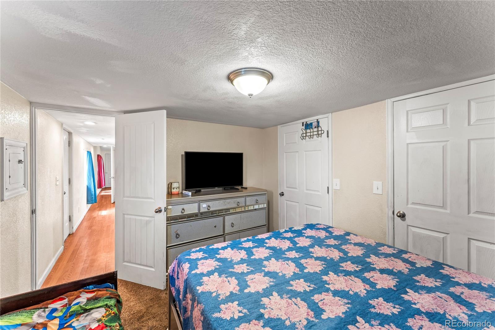 75 North Curtis Road Colorado Springs, CO 80930 - Photo 16 of 19 a bedroom with a bed and a flat screen tv