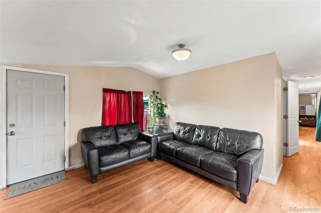 a living room with stainless steel appliances granite countertop furniture and a kitchen view