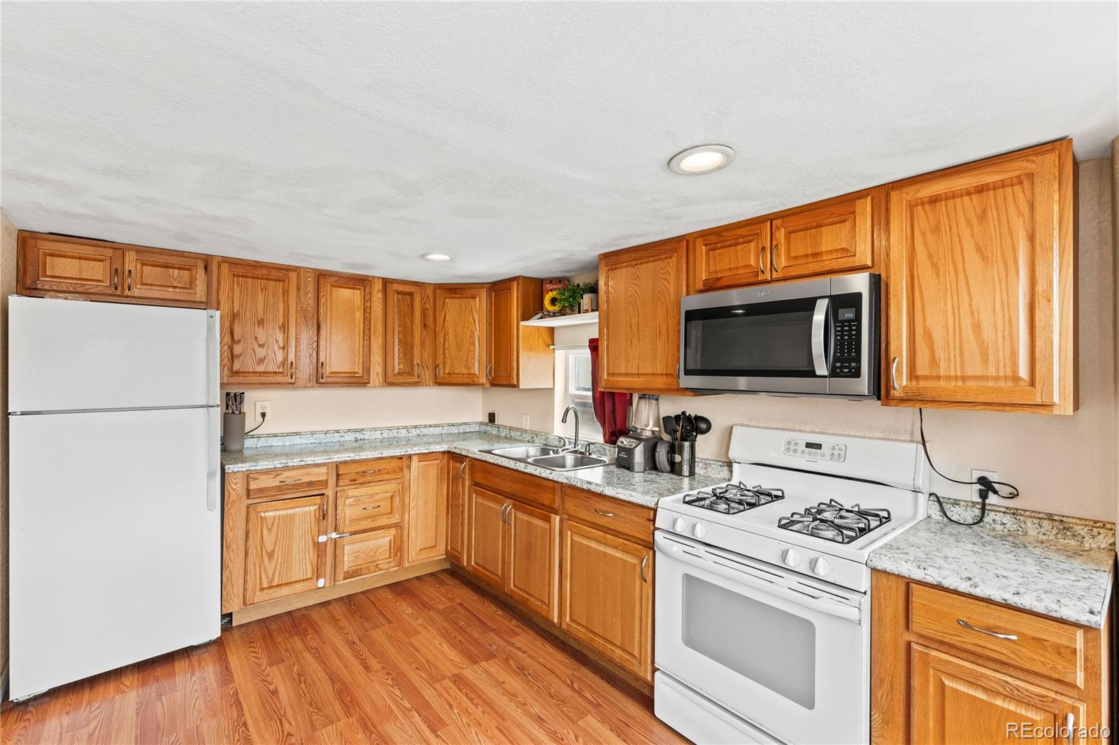 75 North Curtis Road Colorado Springs, CO 80930 - Photo 7 of 19 a kitchen with a sink stove and microwave