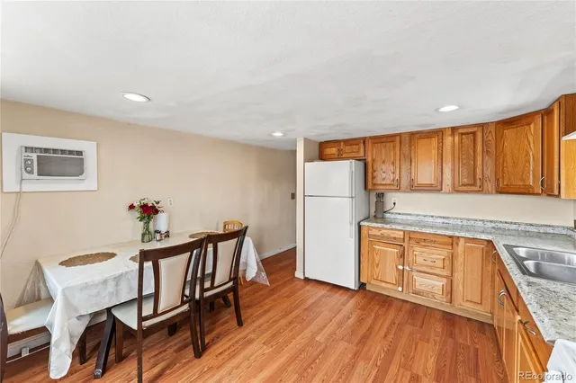a large kitchen with a wooden floor and cabinets