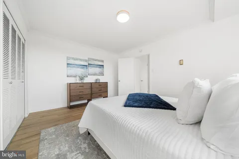 a bedroom with a bed and a painting on the wall