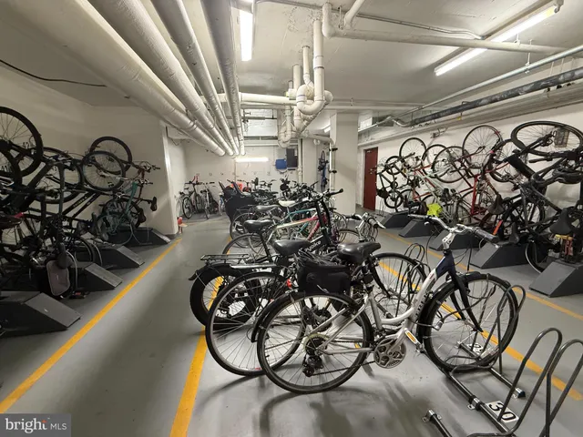 a living room with furniture and a gym cycle
