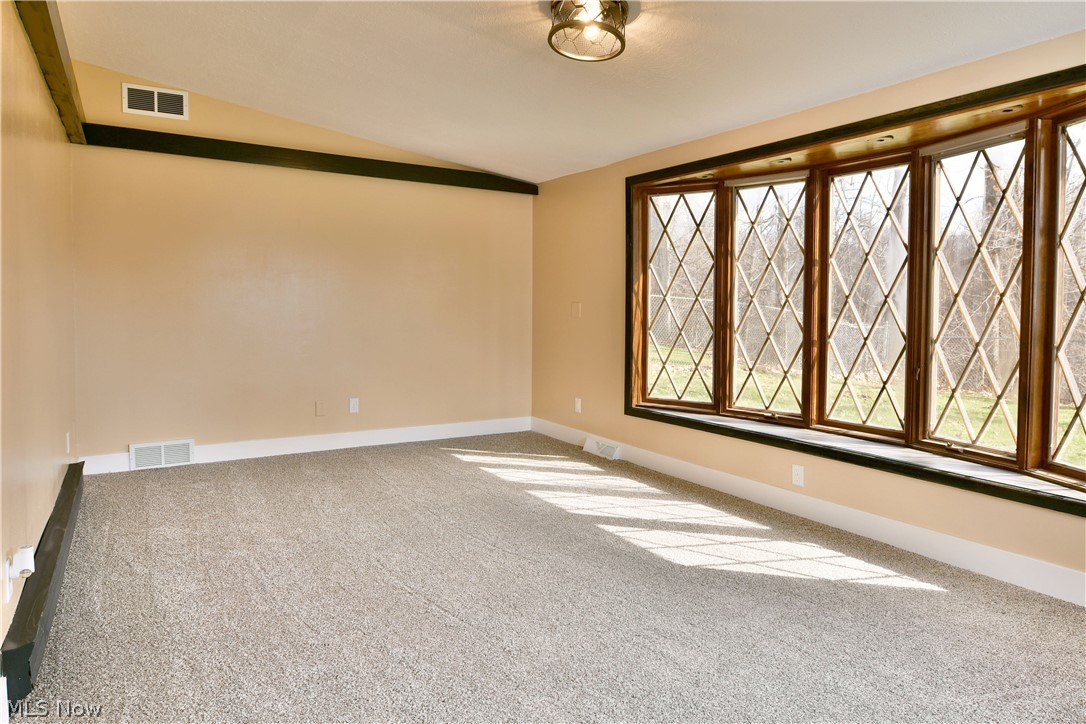 105 Fairview Avenue Cortland, OH 44410 - Photo 24 of 47 Empty room with lofted ceiling and light carpet