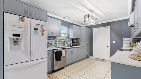 a kitchen with stainless steel appliances a refrigerator and a stove top oven