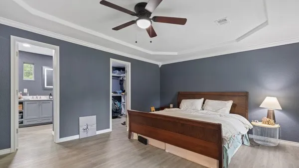 a bedroom with a bed and a chandelier