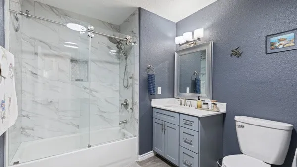 a bathroom with a sink toilet tub and shower
