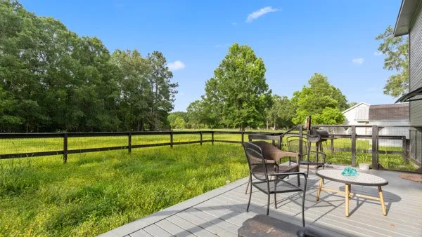 a view of backyard with seating area and trees