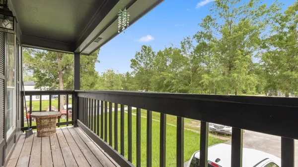 a view of balcony with wooden floor