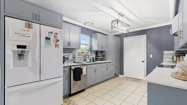 a kitchen with stainless steel appliances a refrigerator and a stove top oven