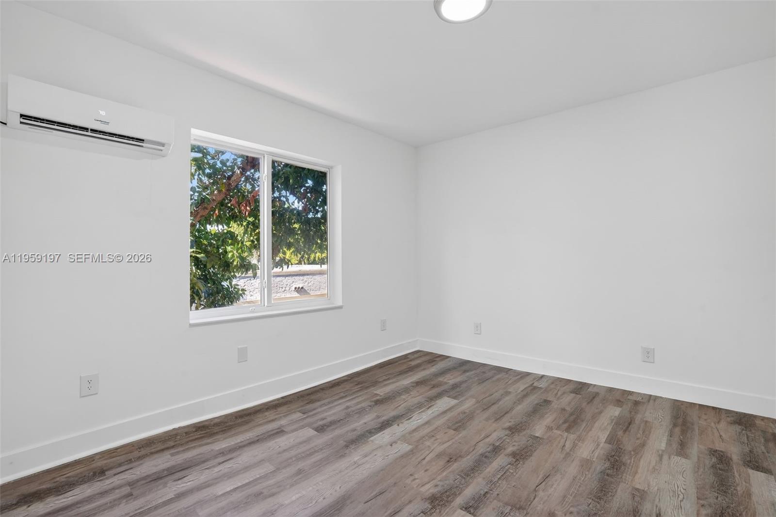 1630 Southwest 10th Street Miami, FL 33135 - Photo 12 of 20 wooden floor in an empty room with a window