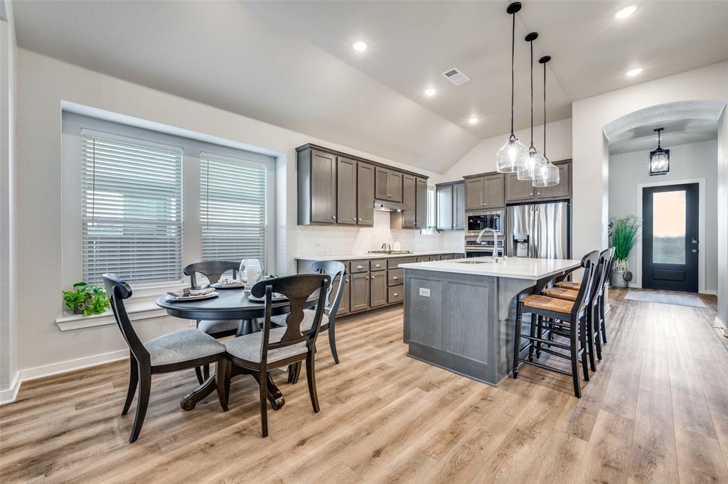 3513 Dusty Miller Road Aubrey, TX 76227 - Photo 12 of 25 a dining room with a wooden table and chairs