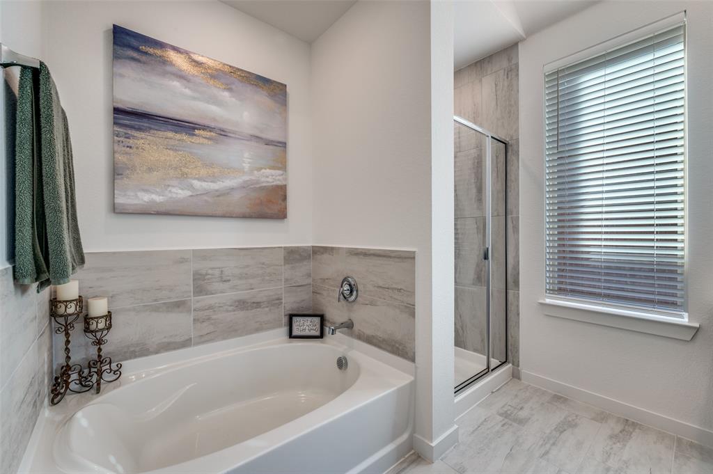 3513 Dusty Miller Road Aubrey, TX 76227 - Photo 17 of 25 a bathroom with a tub and shower