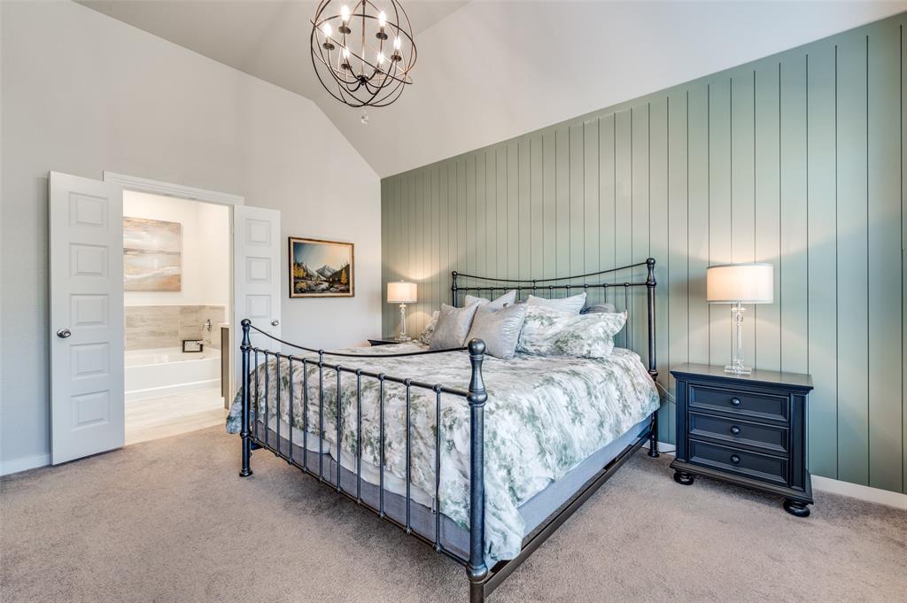 3513 Dusty Miller Road Aubrey, TX 76227 - Photo 18 of 25 a bedroom with a bed and a chandelier