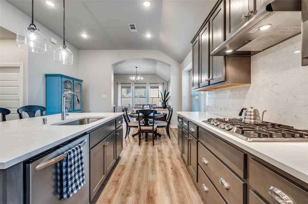 3513 Dusty Miller Road Aubrey, TX 76227 - Photo 10 of 25 a kitchen with stainless steel appliances granite countertop a sink stove and cabinets