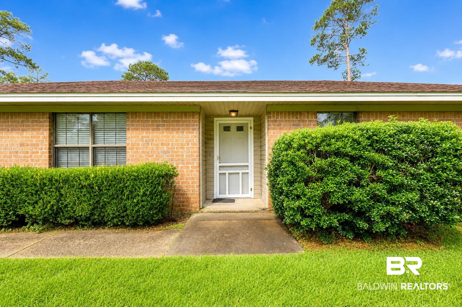 614 East Gate Circle Foley, AL 36535 - Photo 3 of 31 Brick exterior featuring a white storm door and an overhead entryway light