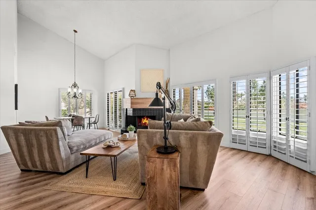 a living room with furniture a lamp and wooden floor