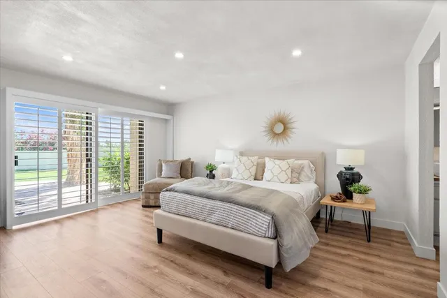 a spacious bedroom with a bed and a large window