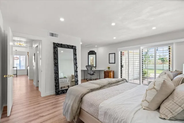 a bedroom with a large bed and a large window