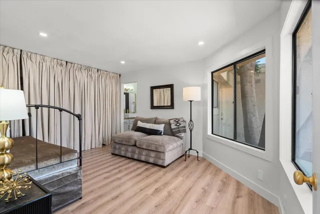 a living room with furniture window and wooden floor