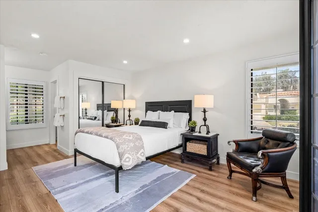 a bedroom with a bed and wooden floor