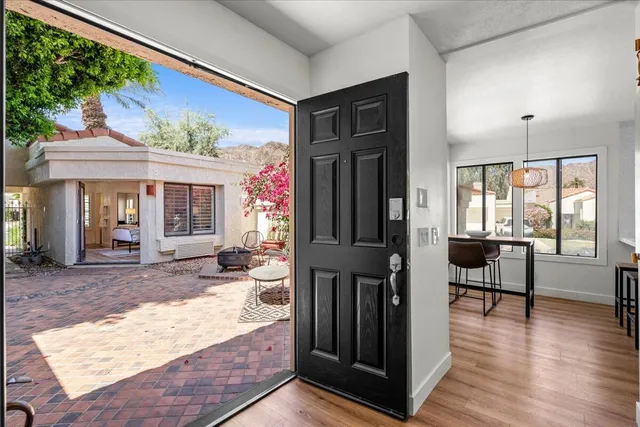a view of a livingroom with furniture window and wooden floor