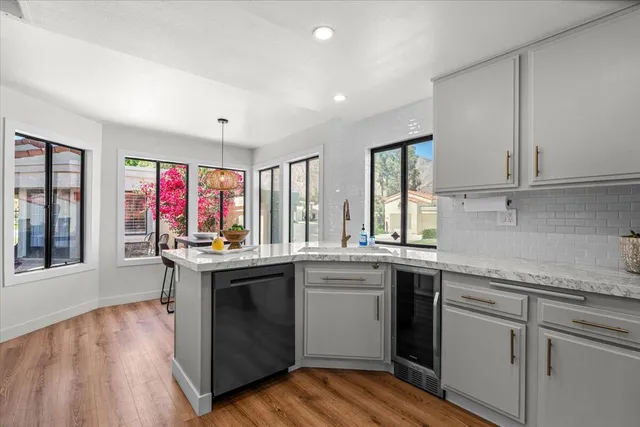a kitchen with stainless steel appliances granite countertop a stove and cabinets