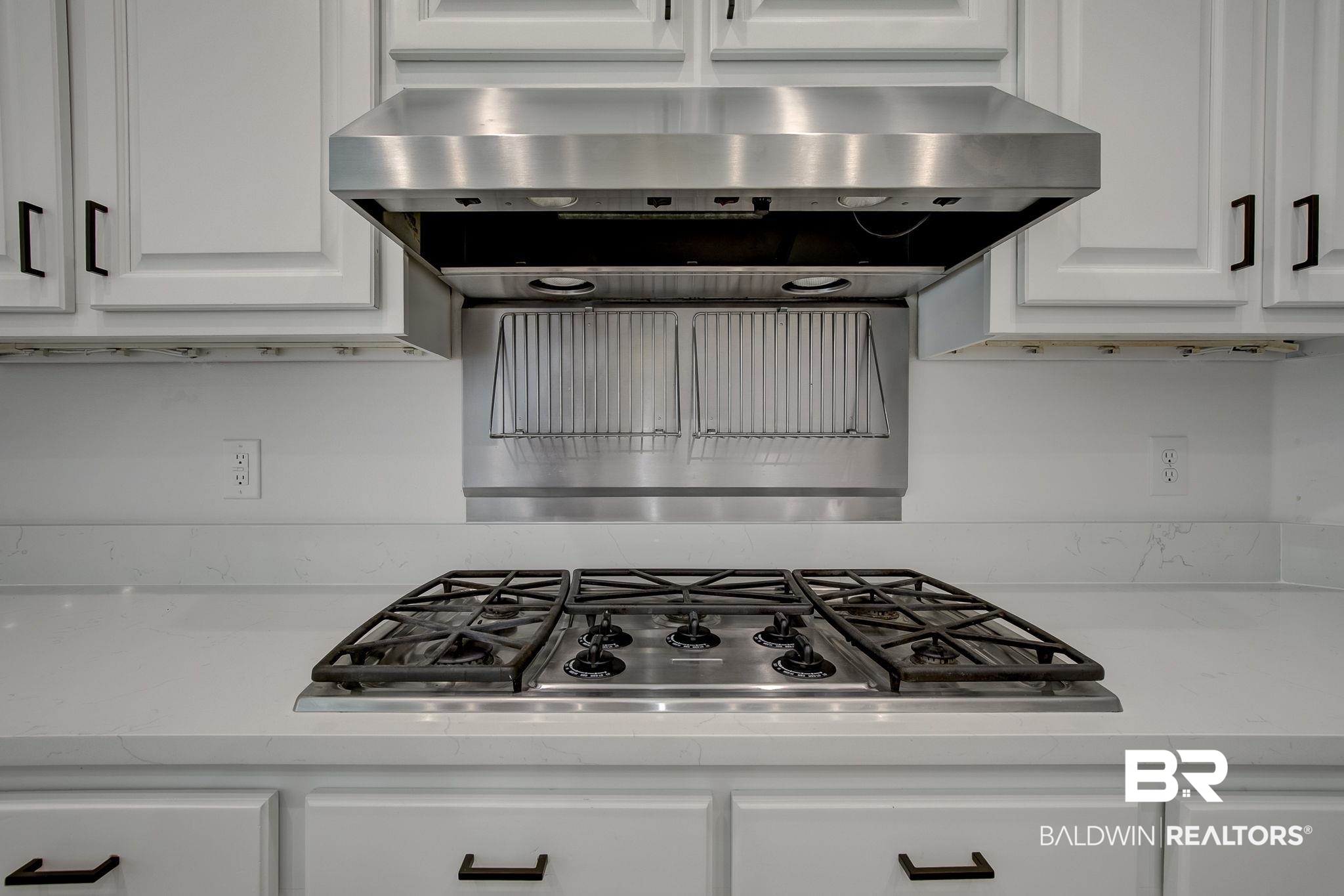 105 High Pines Ridge Fairhope, AL 36532 - Photo 33 of 97 Kitchen featuring stainless steel gas cooktop, white cabinets, and wall chimney exhaust hood