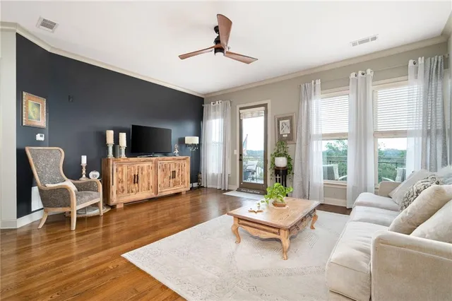 a living room with furniture and large windows