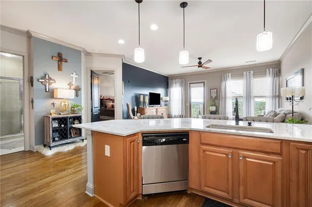 a kitchen with kitchen island a sink stove and wooden floor