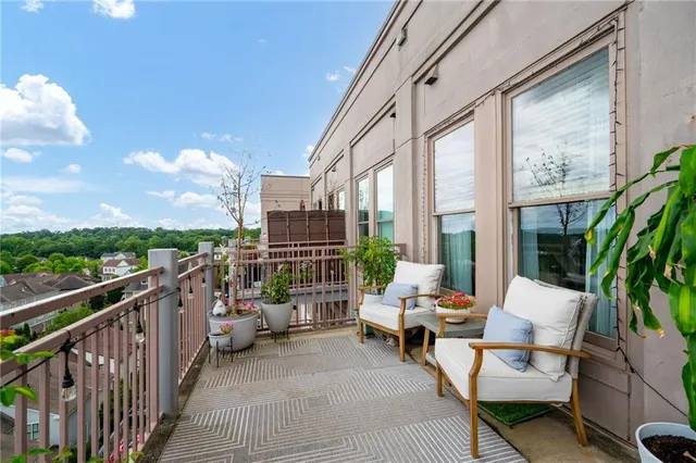 a balcony with furniture and city view