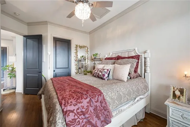 a bedroom with a large bed and a chandelier