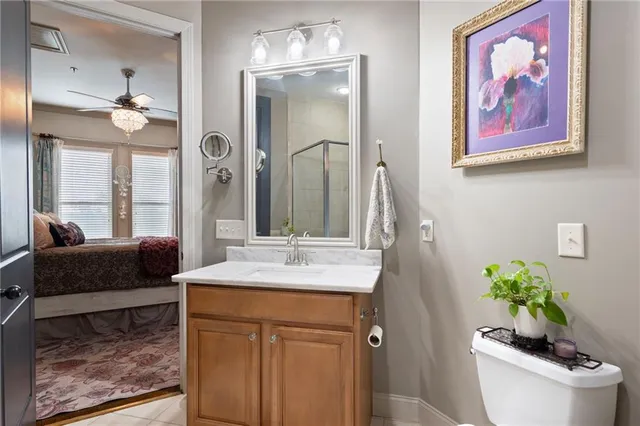 a bathroom with a granite countertop sink a toilet and a mirror