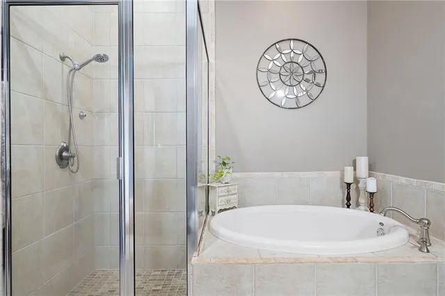 a bathroom with a white tub and a shower