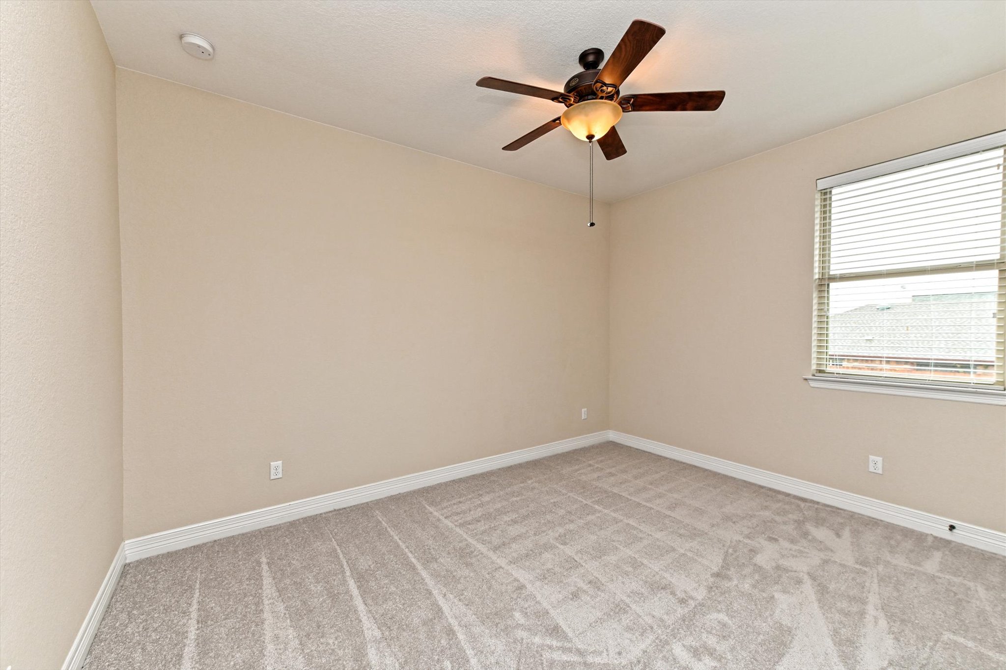 18500 Rio Chama Lane Austin, TX 78738 - Photo 24 of 28 This room features light-colored walls and grey carpeting
