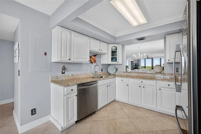 a kitchen with cabinets appliances and a window