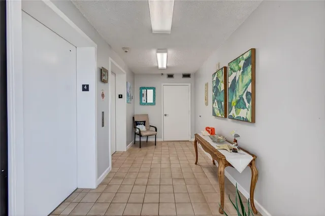 a hallway with a desk and chair