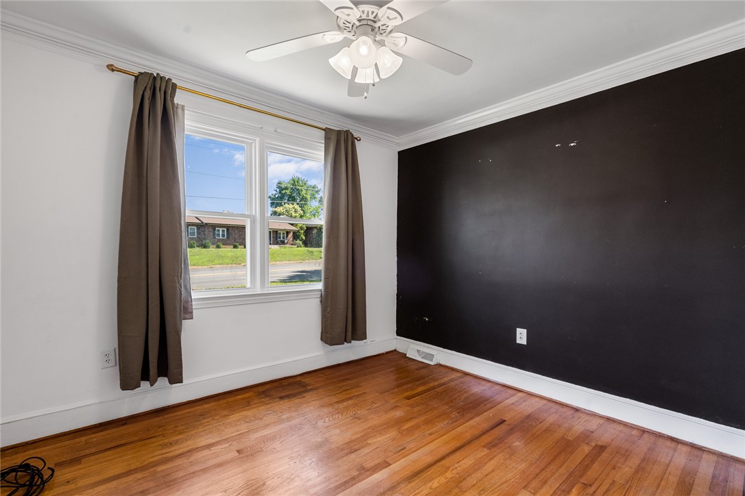 419 Whitehall Road Anderson, SC 29625 - Photo 14 of 28 Hardwood flooring extends throughout this naturally illuminated room, complete with a ceiling fan for comfort.