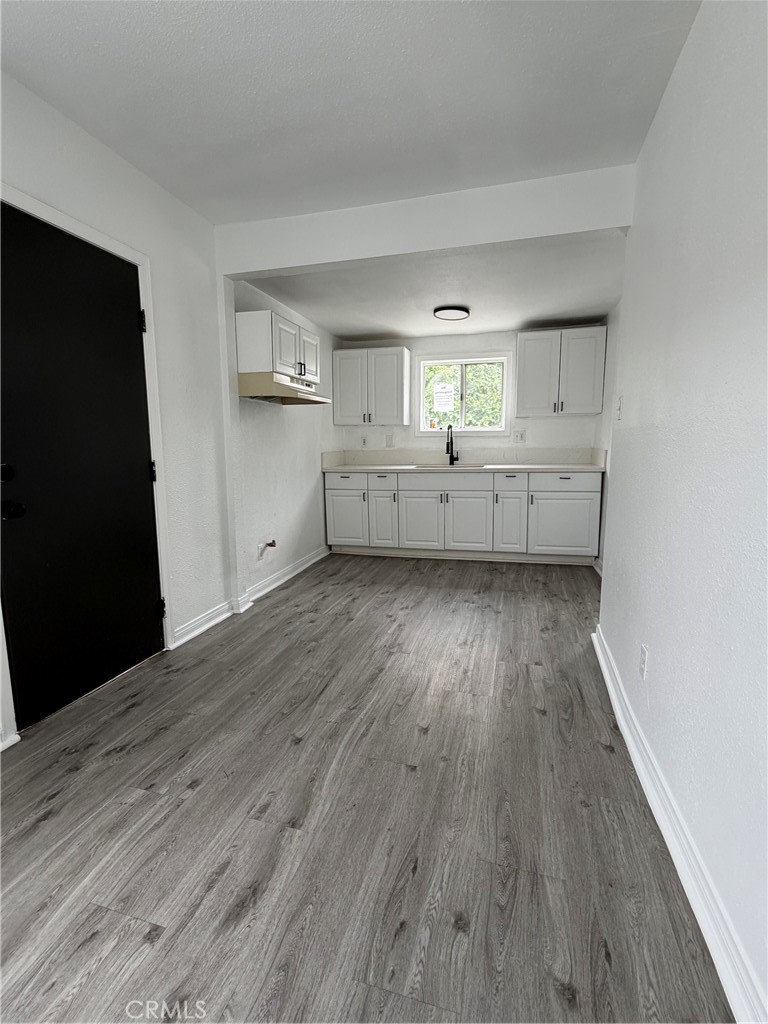 304 West Cedar Street Compton, CA 90220 - Photo 8 of 9 an empty room with wooden floor and windows