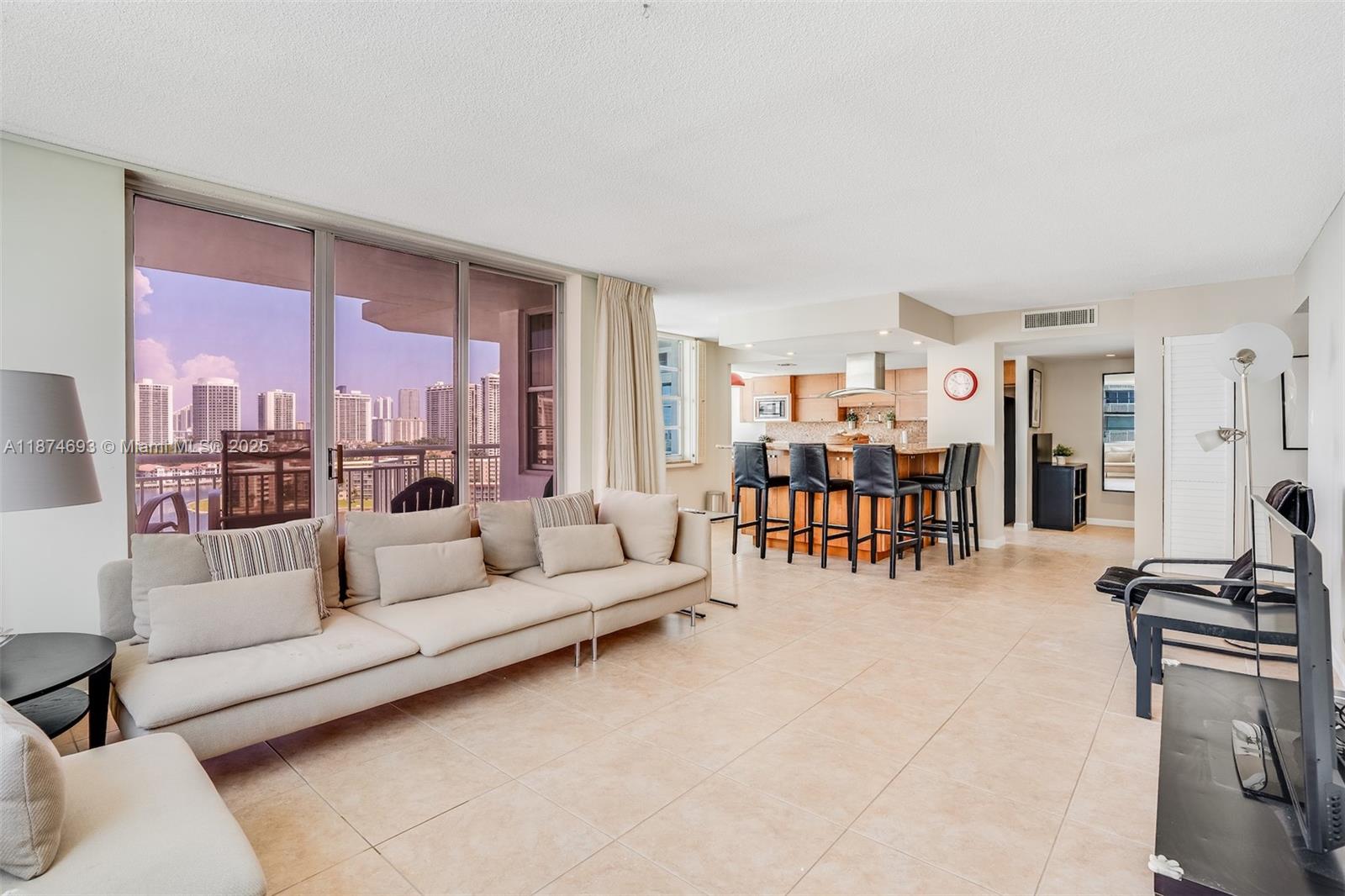 18041 Biscayne Boulevard, Unit 1404 Aventura, FL 33160 - Photo 12 of 22 a living room with furniture and kitchen view