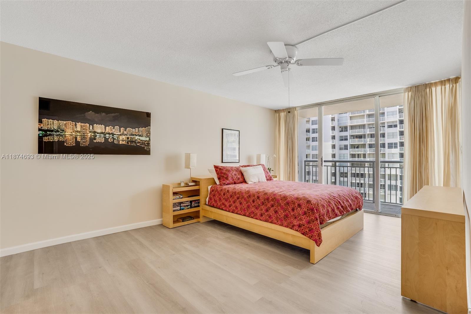 18041 Biscayne Boulevard, Unit 1404 Aventura, FL 33160 - Photo 15 of 22 a bedroom with a bed and a flat screen tv
