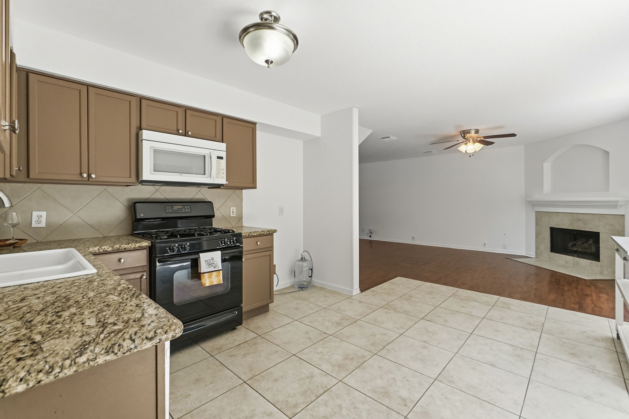 11907 Ezekiel Road Tomball, TX 77375 - Photo 13 of 39 a kitchen with granite countertop a stove and a sink