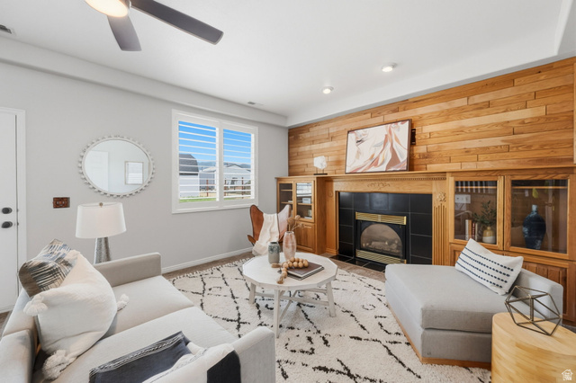3732 Campbell Road Tooele, UT 84074 - Photo 26 of 69 Living area featuring a fireplace with a black tile surround, a wood mantle, and built-in cabinetry