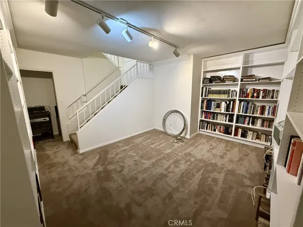 a view of a livingroom with furniture and staircase