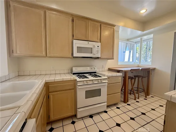 a kitchen with a stove a sink and a microwave