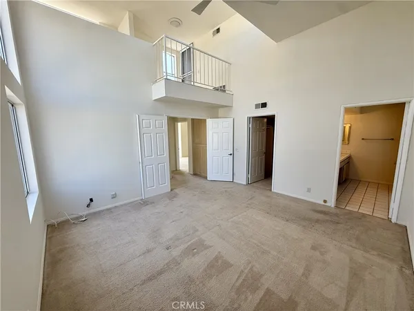 a view of an empty room with a ceiling fan