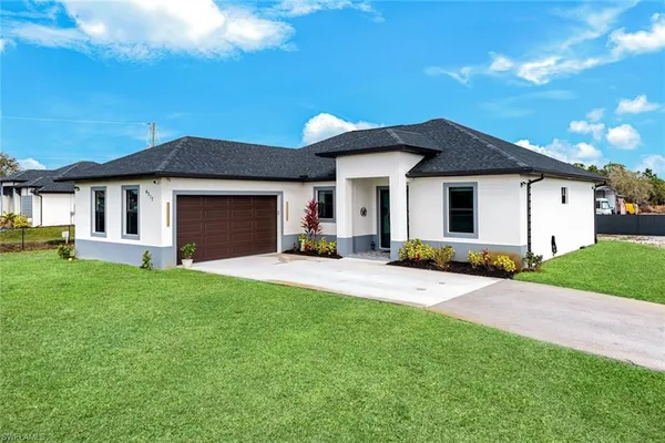 a front view of a house with a yard and garage