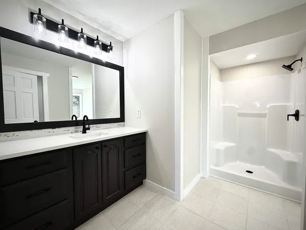 a bathroom with a double vanity sink mirror double and shower