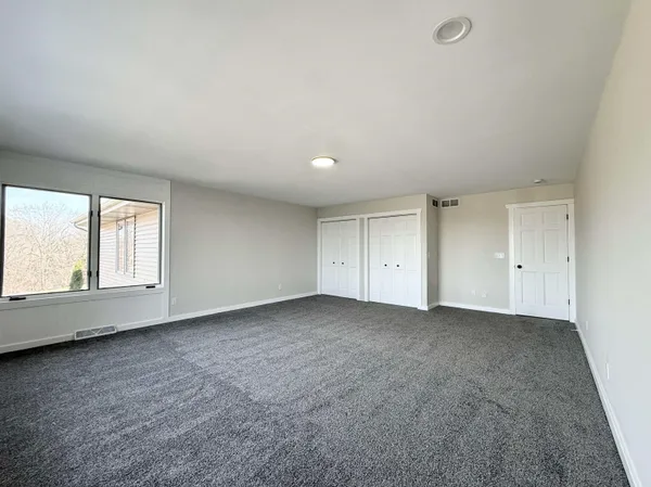 an empty room with a empty space and windows