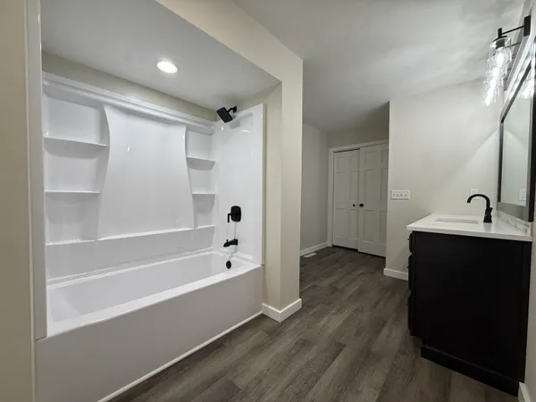 a bathroom with a bathtub and a sink