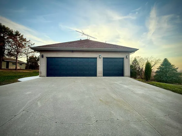 a view of a house with a yard and garage
